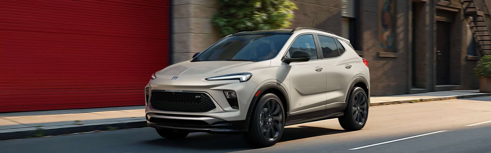 Buick SUV driving through a city street.