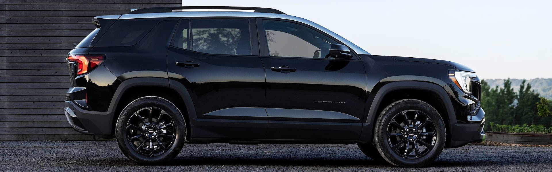 Side profile of a black GMC Terrain SUV with black wheels